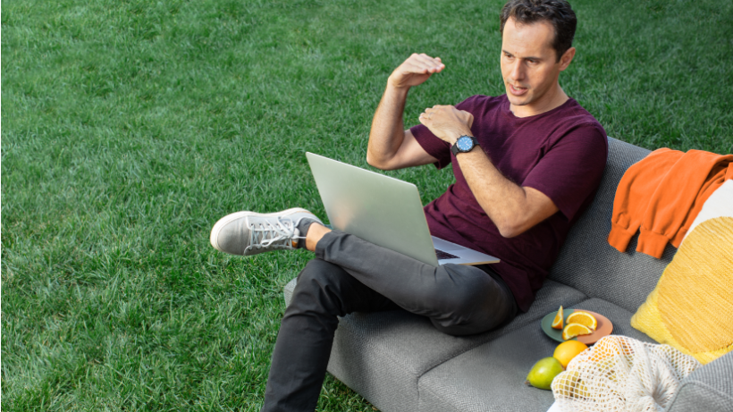 A man taking a video call from outside, gesturing as he talks about a Mailchimp product he’s become a fan of.